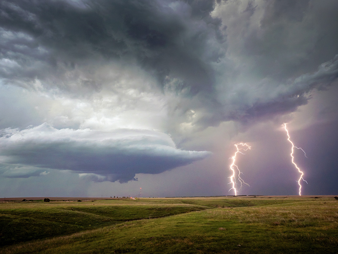 Multiple lightning bolts rip down with fury, from a highly powerful supercell over farmland in Nebraska.⁠
⁠
Last week I posted a photo of a stovepipe tornado that lasted roughly an hour near Wellfleet, Nebraska. To put down such a powerful and long-lasting tornado requires a massively powerful supercell. Once the tornado receded, this storm was in no way done producing. Except instead of additional tornadoes, it produced what seemed like an infinite number of lightning bolts.⁠
⁠
When multiple bolts are seen in the same general area, this is usually an indicator of the updraft or downdraft intensifying. And intensifying it must have been, as lighting bolts were pouring down every few seconds, often in the same area. Which, if you are trying to photograph lighting, makes the job a lot easier. Not only can you frame the photo for where the bolts are generally contacting, it gives you multiple tries to get the best result. On this particular evening, during maybe 10 minutes spent watching this storm from this location, I photographed at least 50 different bolts, with this frame capturing these two powerful and awe-inspiring bolts at once.