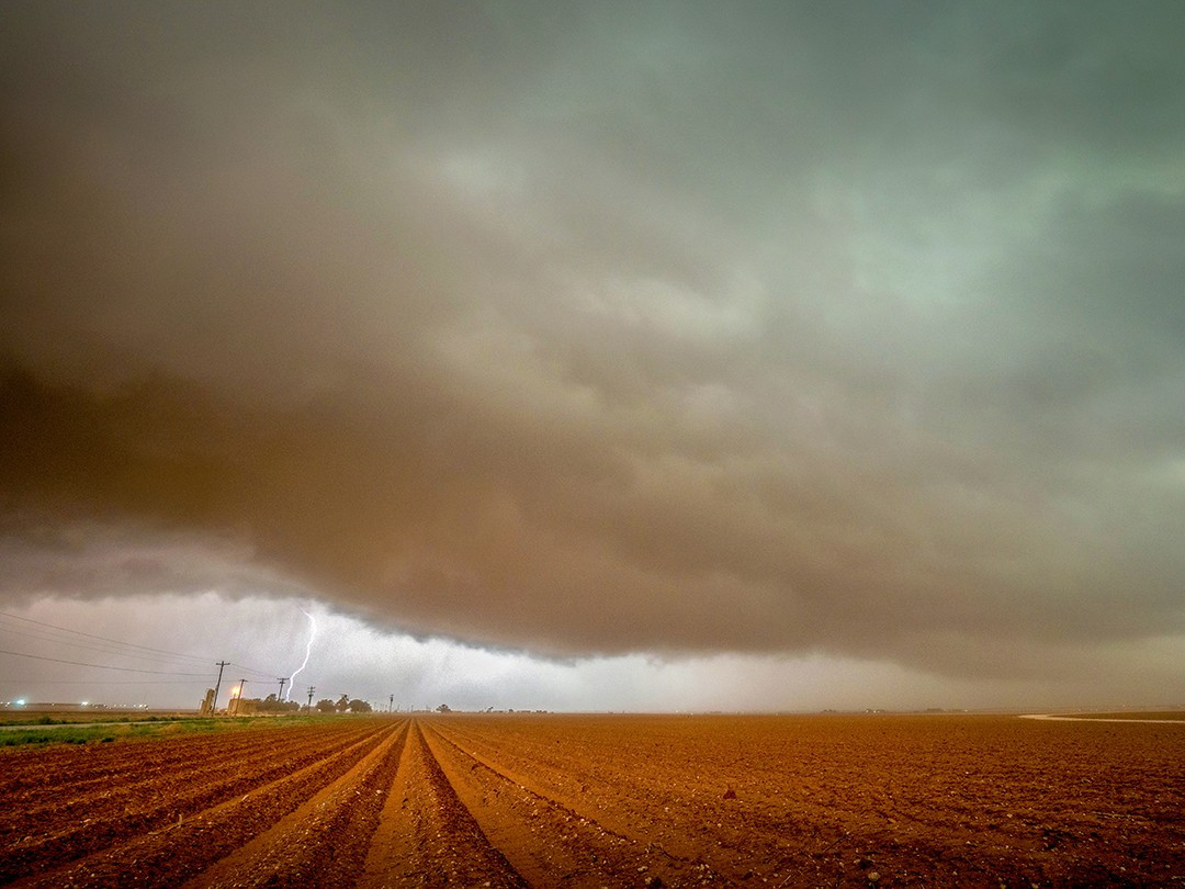 A massive dust-filled supercell passes over a freshly plowed field in the plains of western Texas.⁠
⁠
Supercells are powerful rotating thunderstorms, and one of their characteristics is a rotating updraft called a mesocycle. And the stronger the updraft, the stronger the storm. When warm, unstable air rises quickly, the powerful updraft created can suck in various debris with it, such as surface dust or dirt.⁠
⁠
During my time following storms in the Midwest, this was commonly observed in the dust coming off of dirt roads being sucked up, usually quite minimally. But, with this particular storm near Lamesa, Texas, the abundance of freshly plowed fields yielded different results.⁠
⁠
The strong updraft combined with the plethora of loose soil led to what is known as mud rain. Since an incredible amount of dirt was pulled up into the storm, this led to a dark and dirty-looking cloud base, with the falling rain then mixing with this dirt mass, essentially raining mud.⁠
⁠
We spent hours tracking this particular storm, and hours is about how long it took me to remove all the dirt and muddy rain drops from my camera gear, clothing, hair, teeth, and even inside my ears. It was a dusty mess to say the least.