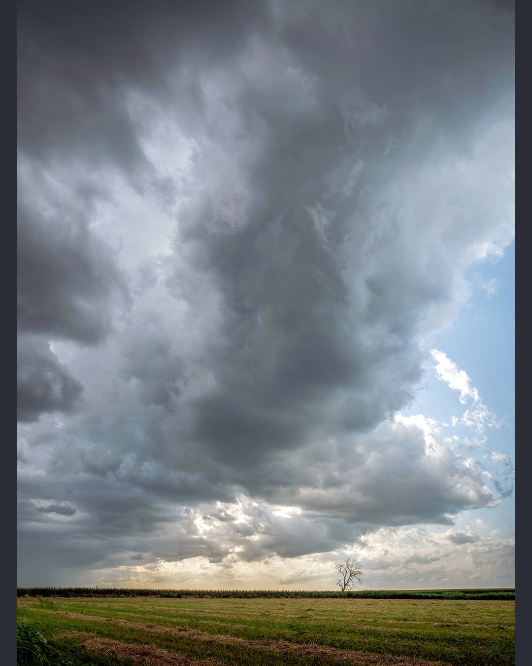 A supercell with lowered wall-cloud passes over some farmland in Lawton, Oklahoma, on June 18th, 2025.⁠
⁠
This was toward the end of a day following this storm passing through southern Oklahoma, which had a strong likelihood of producing a tornado. Although no tornado formed on this day, the storm exhibited a strong, persistent rotating updraft, and a wall cloud which could have easily transformed into one. Wall clouds form when warm, moist inflow is pulled upward into the storm’s updraft. As this warm air rises, it cools and condenses at a level lower than the existing cloud base, creating a lowering known as a wall cloud.⁠
⁠
We pulled over on the side of the road here next to a bunch of farmland, which, if you are traveling around Oklahoma, is quite abundant. Waiting for a tornado to potentially form, while we may not have witnessed a tornado on this day, we were certainly exposed to plenty of strong wind, rain, hail, and lightning.