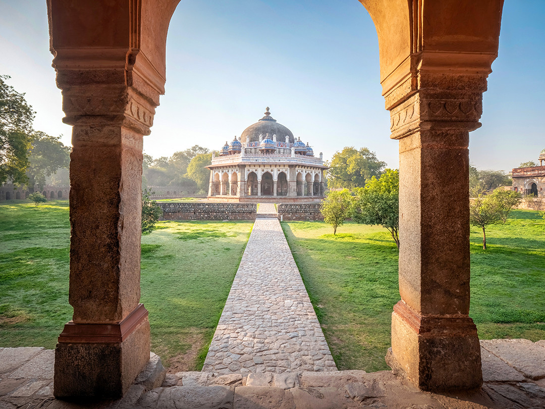 The Tomb of Isa Khan stands beyond the sandstone archways and gardens of Delhi, India.⁠
⁠
Inside of the Humayun’s Tomb complex in Delhi, and actually predating Humayun’s Tomb by about two decades, this tomb for Isa Khan Niyazi, a noble in the court of Sher Shah Suri during the Sur dynasty period, was built in the 1540s. This tomb sits inside of a walled-in garden enclosure and is one of the earliest examples of a garden-tomb setting in India today.⁠
⁠
On this particular day, I had an action-packed day inside of Delhi. Starting with photographing a flower market at 4am, before the sun even rose, I then proceeded to India Gate to see and photograph the sunrise from it. After the sun broke the horizon, I headed to Humayun’s Tomb, as I wanted to get there early enough to beat out the crowds that would trickle in throughout the day. When approaching the massive structure that is Humayun’s Tomb, you first encounter a side path which leads to the Tomb of Isa Khan, which is almost equally impressive in its design and garden.