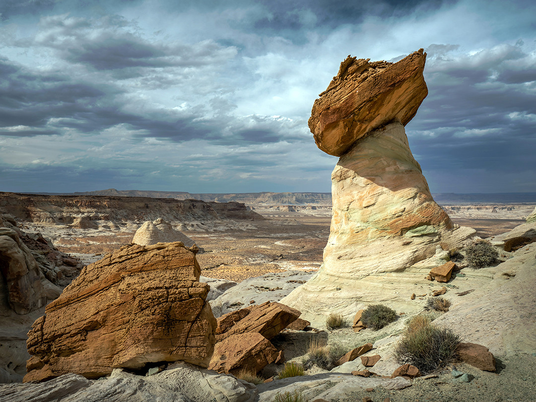 A large sandstone mushroom hoodoo perched on the edge of a canyon at Stud Horse Point, Arizona.⁠
⁠
Mushroom hoodoos, also known as toadstool hoodoos, balanced rock hoodoos, or pedestal hoodoos, are named for their bulbous caps, which are larger than the supporting columns beneath them. Their iron-rich caps are much more resistant to erosion than the softer sandstone below, causing the surrounding rock to weather away more quickly, leaving behind the characteristic mushroom or toadstool shape for which they are named. Once this shape develops, the larger cap acts like an umbrella, shielding the narrower pedestal below from further erosion.⁠
⁠
I recently spent a few days in Page, Arizona, and if you’ve been there, you likely visited both Horseshoe Bend and Antelope Canyon, the two attractions for which the area is best known. But a 30-minute drive from Page will take you to Stud Horse Point, a landscape filled with these otherworldly hoodoos. I actually enjoyed photographing here more than either Horseshoe Bend or Antelope Canyon, both because of the uniqueness of the rock formations and because I had the entire place to myself for the couple of hours I spent exploring (which is the exact opposite at those other spots). You need a 4x4 vehicle, or at the very least a high-clearance one, to make the trip. But if you have one and find yourself in the Page area, this location is absolutely worth a visit.